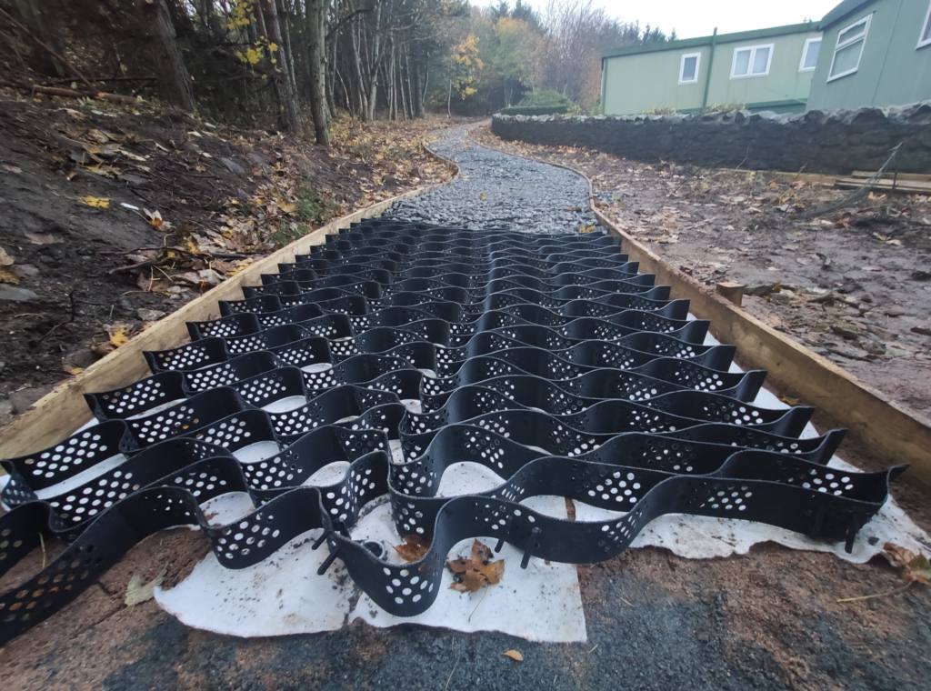 A layer of geogrid cells laid out in preparation for laying the Auchmill Woodland Path