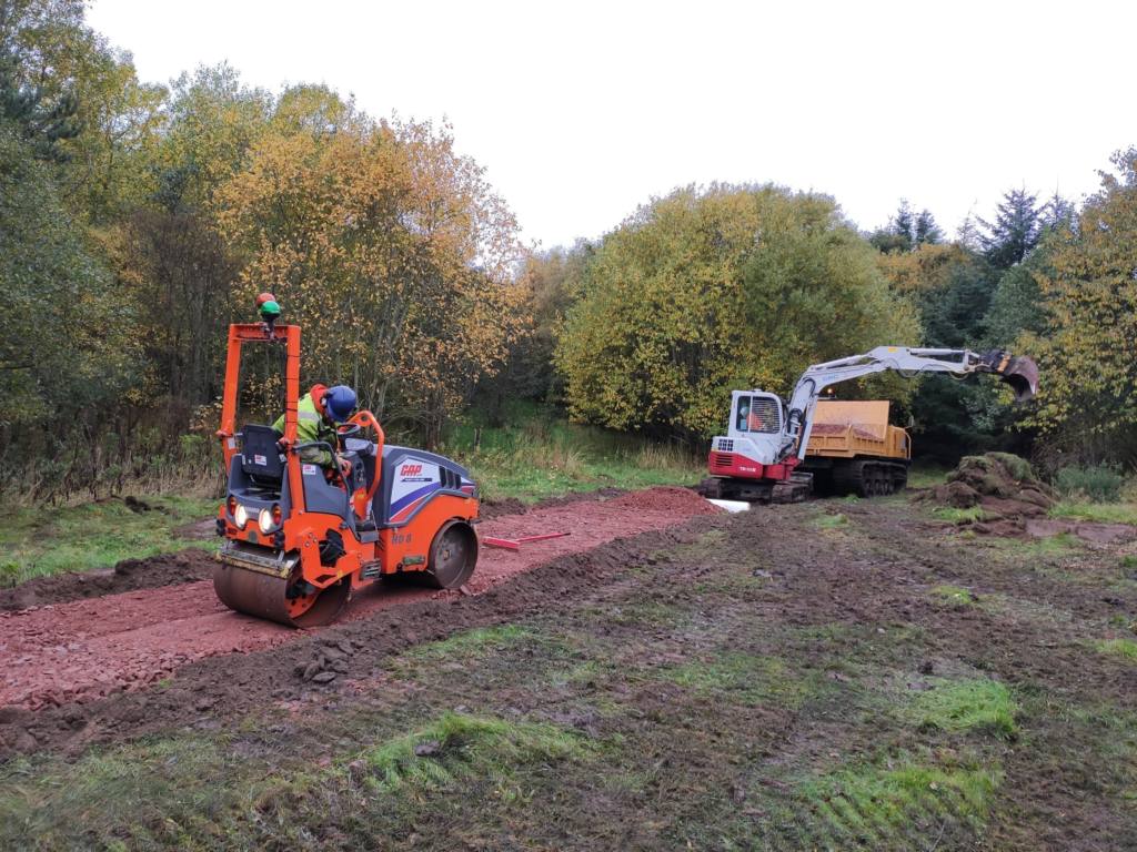 CRC Crew Member Using a Steamroller to Level the Auchmill